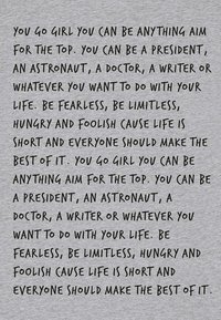 Tissu gris arborant un texte noir manuscrit avec des phrases motivantes sur l'ambition et la vie. Le texte est en gras et irrégulier, créant un effet visuel dynamique.