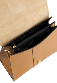 Tan leather handbag with a smooth finish, gold hardware, open flap, and a black interior featuring zippered compartments and logo print.