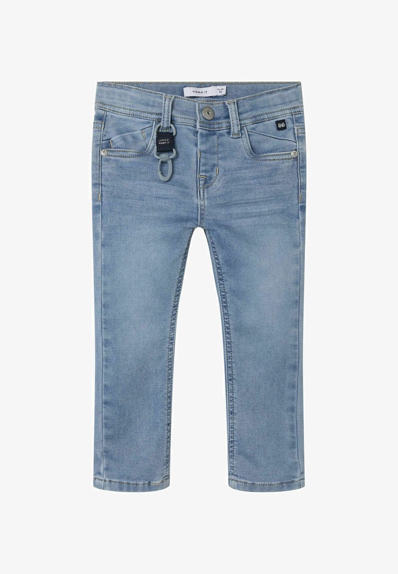 Hellblaue Denim-Jeans mit schmalem Schnitt, frontalen Taschen, einem kleinen schwarzen Etikett und einer grauen Schlaufe für Accessoires. Sichtbare Nähte entlang der Nähte.