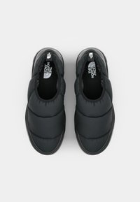 Black puffy slip-on shoes with a padded textile upper and rubber sole. Features logo on the insole and subtle stitching detail.