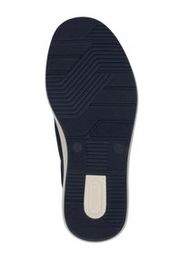Navy rubber shoe sole with textured grip patterns, smooth accents, and a contrasting cream-colored logo at the heel.