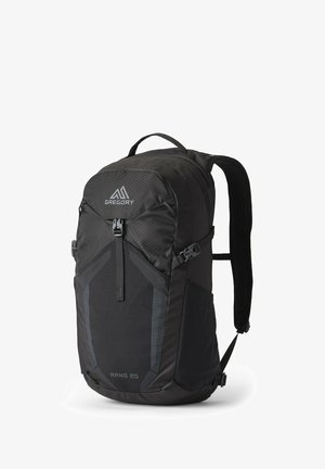 Black backpack with a streamlined design, featuring textured fabric, a front zip pocket, logo, and padded shoulder straps. Model: Nano 20.