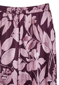 Tissu violet avec de grands motifs floraux et de feuilles en rose pâle. Taille élastique avec une texture douce, adaptée à un usage décontracté.