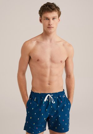 Schwimmshorts aus marineblauem Stoff mit bunten Eisbecher-Mustern. Elastischer Bund mit Kordelzug, zwei seitliche Taschen.