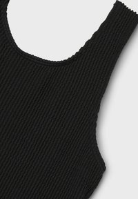 Débardeur noir côtelé avec un col large et un tissu texturé. Le matériau présente des rayures verticales créant une surface tactile.