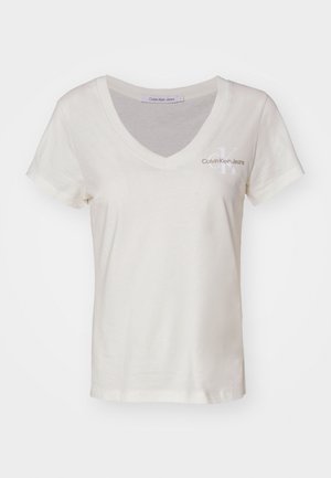 Biała bawełniana koszulka z dekoltem w serek i krótkimi rękawami. Posiada małe logo Calvin Klein Jeans na lewej piersi. Gładka faktura.