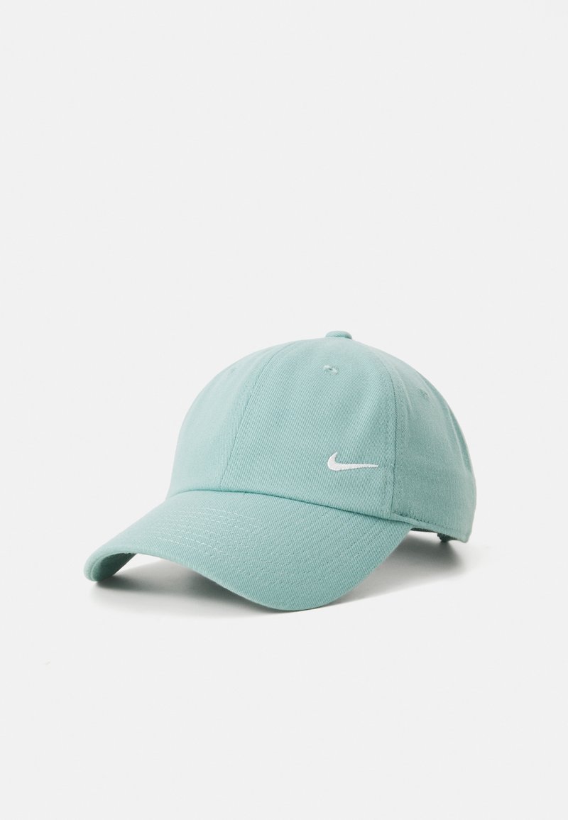 Turquoise Nike cap with a curved brim, textured fabric, and a white swoosh logo on the front. Classic six-panel design.