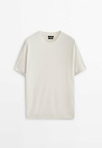 T-shirt à manches courtes, col rond en beige clair, mettant en avant un motif tricoté texturé et un ourlet droit, fabriqué à partir d'un mélange de coton doux.