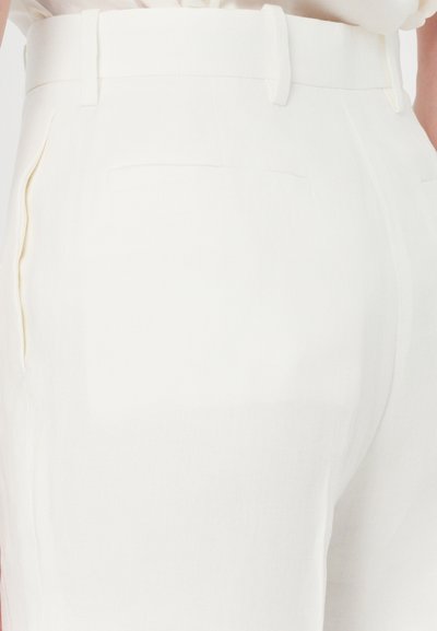 White linen trousers featuring a smooth texture, side pockets, and a flat waistband. Rear pockets with a clean finish visible.