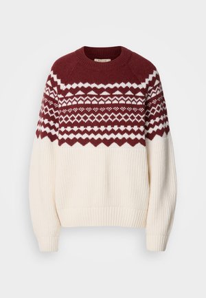 Knitted sweater with a maroon and white geometric pattern on the yoke, featuring a cream body, ribbed cuffs, and hem. Round neckline.