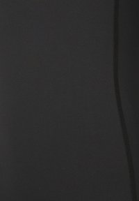 Schwarzer sportlicher Stoff mit glatter Textur, der kontrastierende schwarze Nähte entlang der Seitennaht zur zusätzlichen Detailveredelung aufweist.