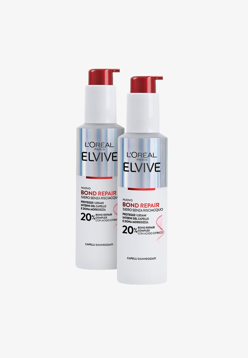 Due bottiglie cilindriche di L'Oréal Elvive Bond Repair. Bianche con lucidi dettagli argento e rossi, dotate di erogatori a pompa e testo nero in grassetto.