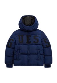 Giacca puffer blu navy con cappuccio alto, caratterizzata da grande scritta nera "GUESS" sul davanti e polsini a coste. Tessuto liscio con design trapuntato.