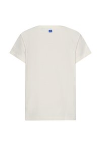 Korte mouwen, crèmekleurig t-shirt van katoen, met een ronde halslijn en een blauw label aan de achterkant. Eenvoudig en strak ontwerp.