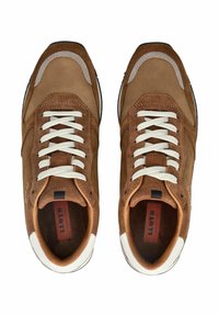 Zapatillas de ante marrón con cordones y acentos blancos, puntera redondeada y paneles laterales texturizados. Suela de goma negra, con un interior contrastante.