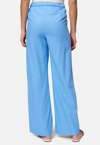 Light blue, wide-leg pants with an elastic waistband and two back pockets, made from a soft, breathable fabric.