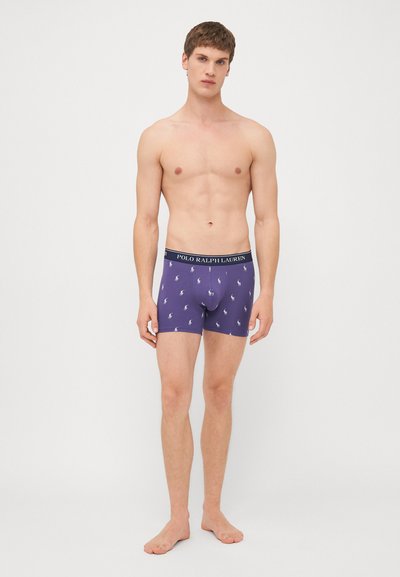 Paarse boxershorts met witte polo-logo patronen, elastische tailleband met "POLO RALPH LAUREN", comfortabele pasvorm, zachte katoenmix.