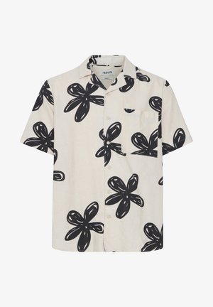 Chemise à manches courtes en tissu beige clair avec de grands motifs de fleurs noires en relief. Comprend une poche poitrine et une fermeture à boutons sur le devant.