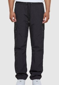 Black cargo pants with an elastic waistband, adjustable drawstring, side pockets, and a relaxed fit. Made of lightweight fabric.