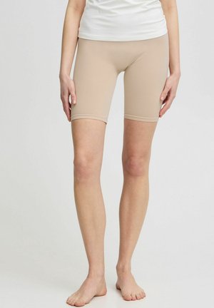 Beige compressiekorte broek, gemaakt van rekbare stof, kniehoogte, met een gladde textuur en zonder zichtbare patronen of hardware.