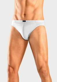 Weiße Baumwollunterhose mit einem Logo-Bund, die eine eng anliegende Passform und eine glatte Textur aufweist, entworfen für Komfort und Unterstützung.