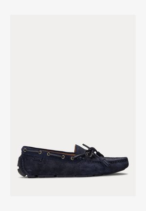Navy blue suede moccasin with lace-up design, round toe, tonal stitching, and metal eyelets. Flexible rubber sole.