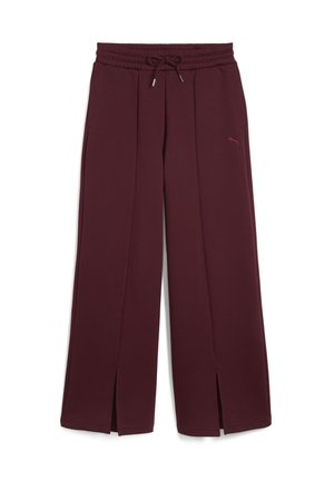 Pantaloni sportivi color borgogna con design a gamba larga, vita elasticizzata, cordino e spacchi laterali. Presenta un piccolo logo Puma in una tonalità abbinata.
