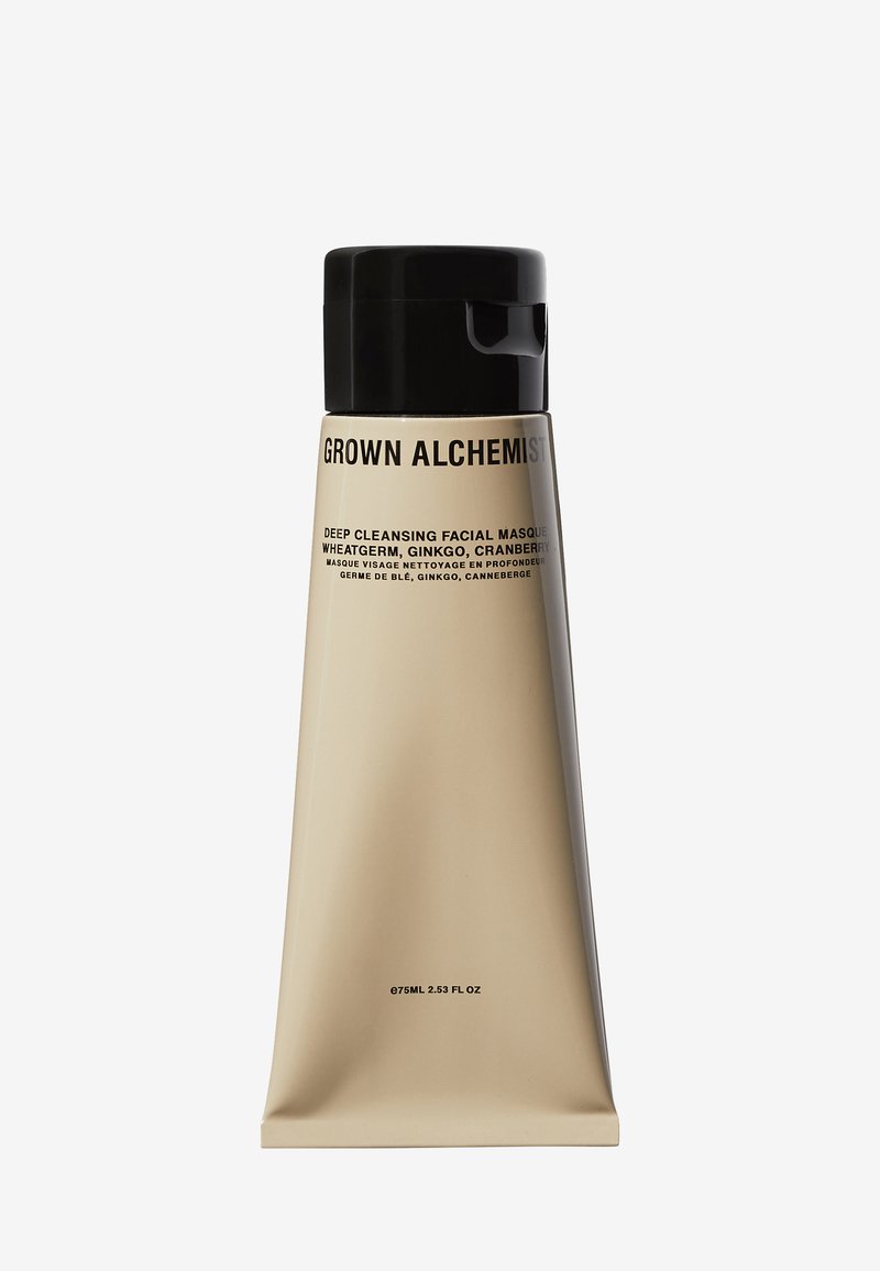 Maschera viso purificante Grown Alchemist in un tubo alto beige con un cappuccio nero. Presenta un testo che indica i contenuti: germe di grano, ginkgo, mirtillo.