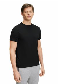 Black short-sleeve t-shirt made of smooth fabric, featuring a classic round neckline and a fitted silhouette. Light grey pants are visible below.