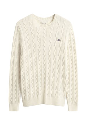 Cremefarvet kabelstrikket sweater med ribbet rund halsudskæring og kant. Lille logo broderet i blåt på brystet. Blødt, tekstureret stof.