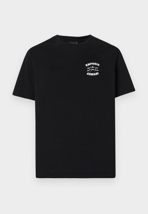 T-shirt en coton noir à manches courtes, avec un petit logo imprimé blanc sur la poitrine avec du texte. Design col rond, coupe régulière.