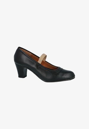 Zapato Mary Jane de cuero negro con tacón bajo, correa elástica color canela y puntera redonda, mostrado de perfil sobre un fondo blanco.