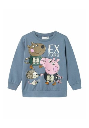 Felpa blu con personaggi dei cartoni animati: un cane marrone e un maiale rosa, con la scritta "ESPLORA!" in bianco e accenti illustrati.