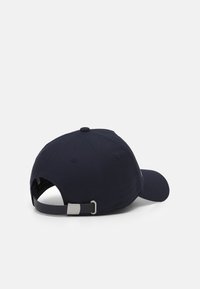 Navy blue baseball cap made of fabric; features a curved brim, metal adjuster, and a button on top; simple design without patterns.