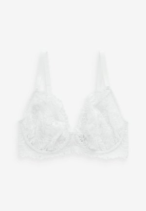Witte kanten bralette met een golvende rand, verstelbare bandjes en een bloemmotief. Lichte, delicate textuur zonder beugels.