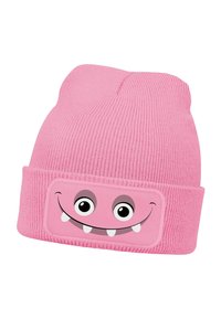 Pink knitted beanie with ribbed texture and rolled cuff featuring a smiling monster face patch with large eyes and sharp teeth.
