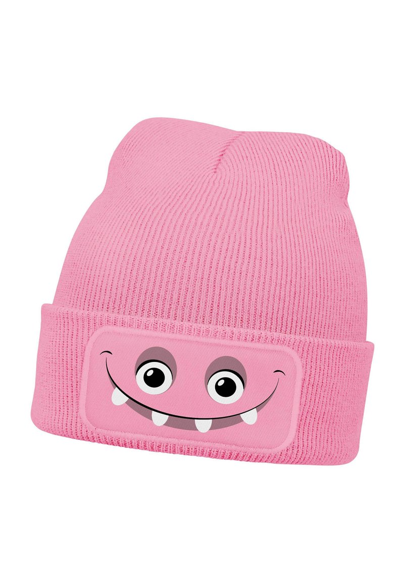 Pink knitted beanie with ribbed texture and rolled cuff featuring a smiling monster face patch with large eyes and sharp teeth.