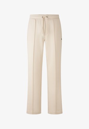 Beige sweatpants med elastisk talje og snøre, prydet med frontfolder og en diskret logo på hoften. Blødt, tekstureret materiale.
