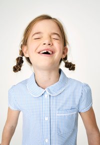 Heled sinine gingham lühikeste varrukatega särk ümmarguse krae, nööpide kinnituse ja valge pitsiga ääristatud taskuga.