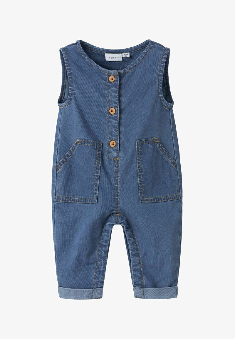 Barboteuse bébé sans manches en denim bleu avec trois boutons à l'avant, deux poches plaquées, et jambes de pantalon retroussées.