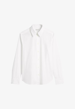 Biała koszula z długim rękawem, wykonana z gładkiej bawełny. Posiada punktowy kołnierzyk, zapięcie na guziki oraz zaokrąglony dół z mankietami na guziki.