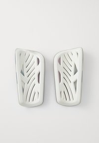 White plastic shoe insoles with a leaf-like design, featuring openings for ventilation. Slightly curved shape with purple accents on the sides.