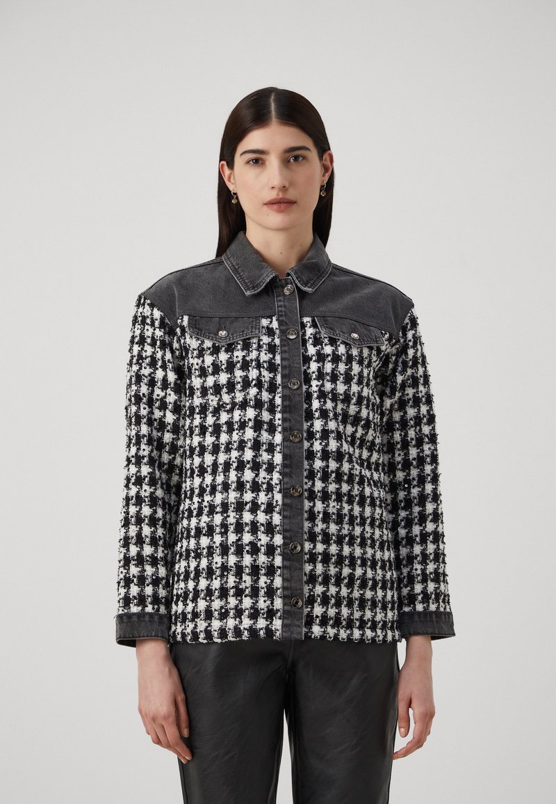 Bunda s čierno-bielym vzorom houndstooth s denimovými akcentmi, zapínanie na gombík a dlhé rukávy. Textúrovaná tkanina, dizajn s golierom.