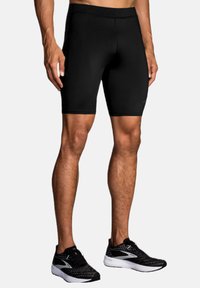 Sorte træningsshorts med en tætsiddende pasform, lavet af strækbart stof, der har en glat tekstur og en sømløs talje.