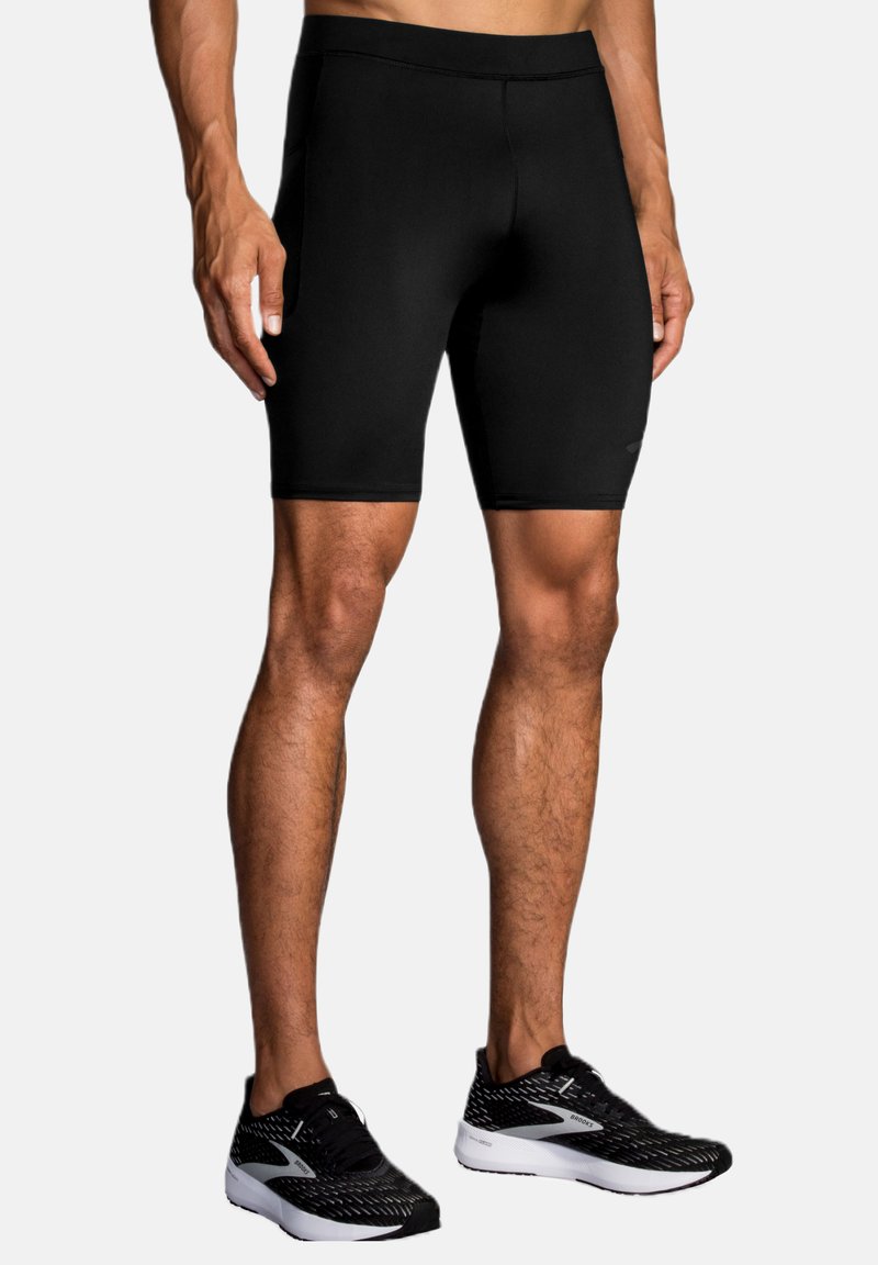 Sorte træningsshorts med en tætsiddende pasform, lavet af strækbart stof, der har en glat tekstur og en sømløs talje.