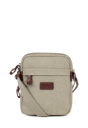 Sac bandoulière carré beige avec poche à rabat sur le devant, tirettes de fermeture éclair en cuir, sangle en tissu ajustable et écusson de marque en cuir sur l’avant.