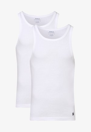 Two white cotton tank tops with round necks and no sleeves. Each features a small black logo at the hem. Smooth texture, simple design.