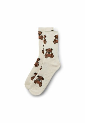 Knee-high socks in cream with a repeating pattern of brown teddy bears, featuring textured soles and a soft, cotton-like material.