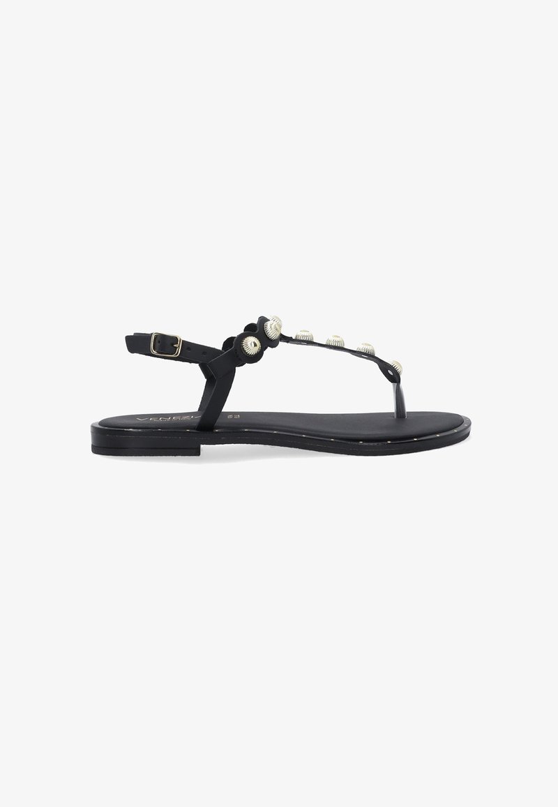 Sort flad sandal med T-strap design, der har dekorative sølvperler og en spænde på ankelstroppen. Glat materiale, minimalistisk form.