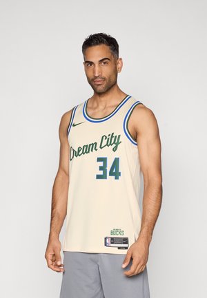 Beige basketball jersey with "Cream City" in green script and number "34" in bold green. Blue and green trim. Nike logo and NBA tag included.